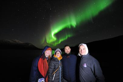 Happy guests under the Northern Lights