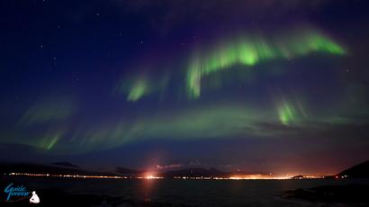 August Aurora over the fjord and Tromsø city