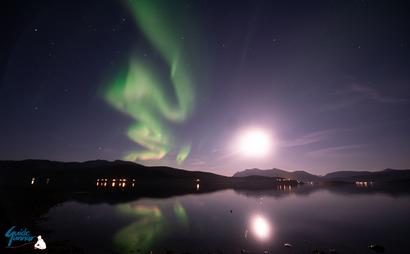 Northern Lights and the moon with reflection in the sea