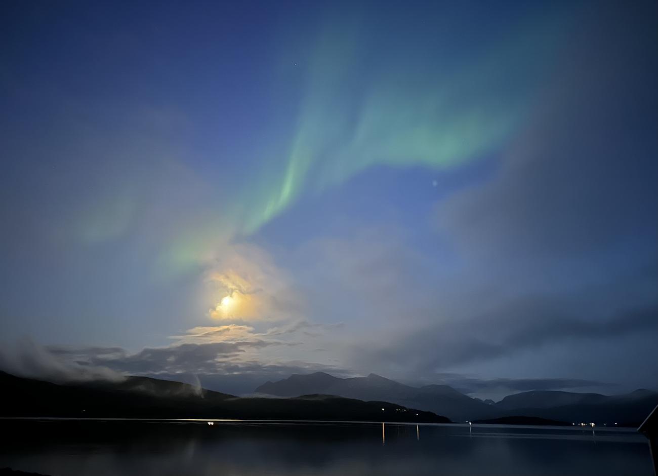 Northern Lights between the clouds in the moon light